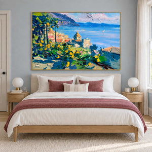 Coastal town painting above a bed with dusty rose bedding.