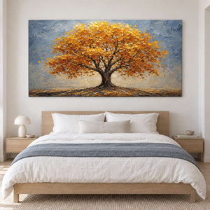 A broad golden autumn tree beneath a gray-blue sky without an outer frame, displayed above a bed.
