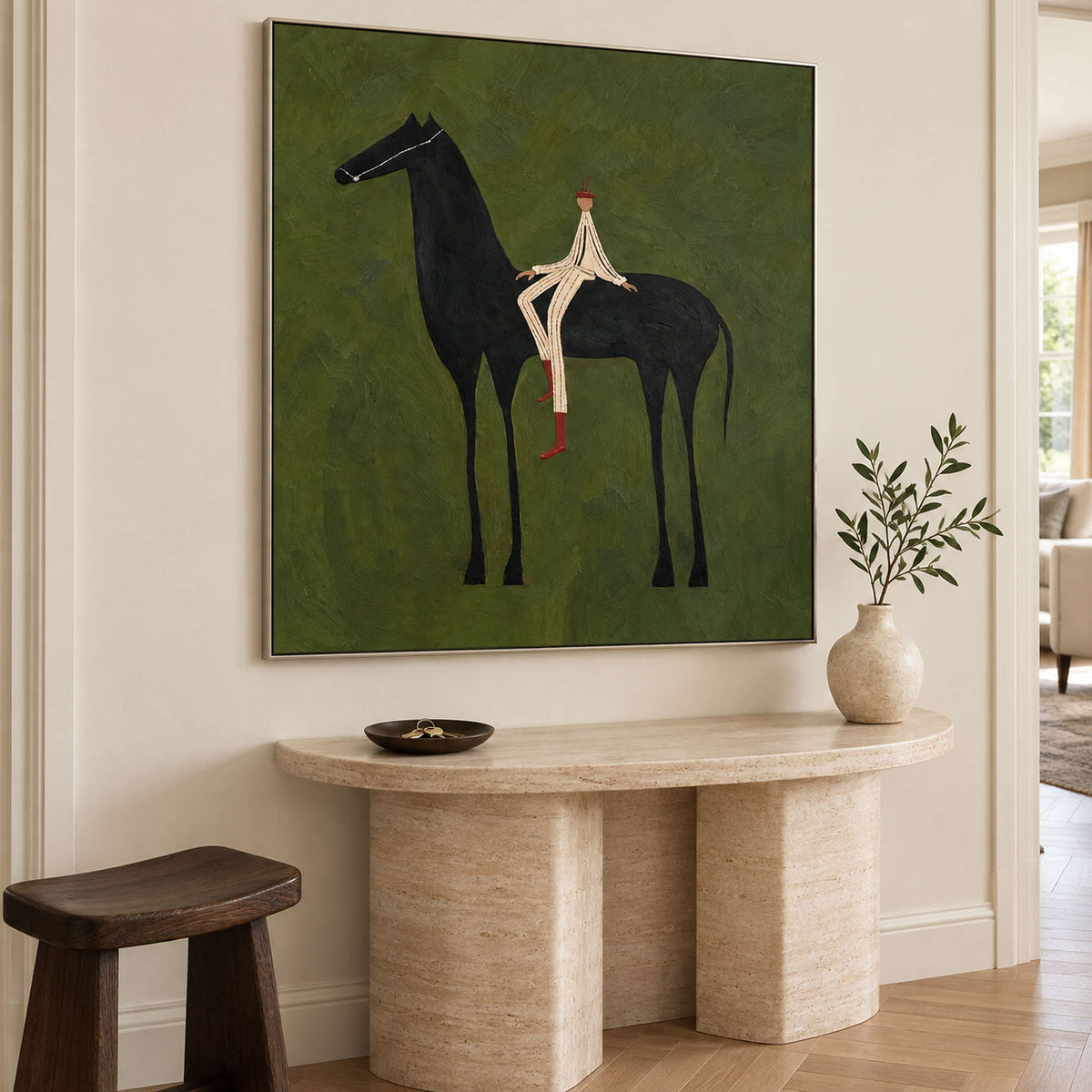 Angled equestrian painting above a pale curved console and dark stool.
