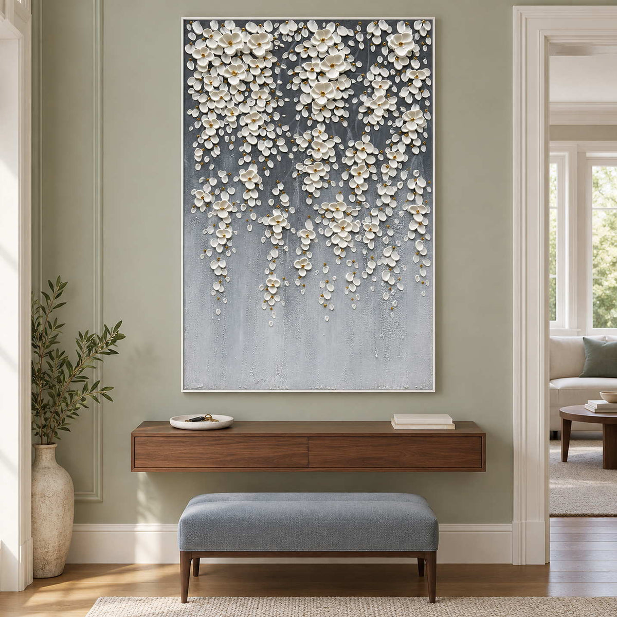 Tall white-flower art over a floating wood console and blue bench.