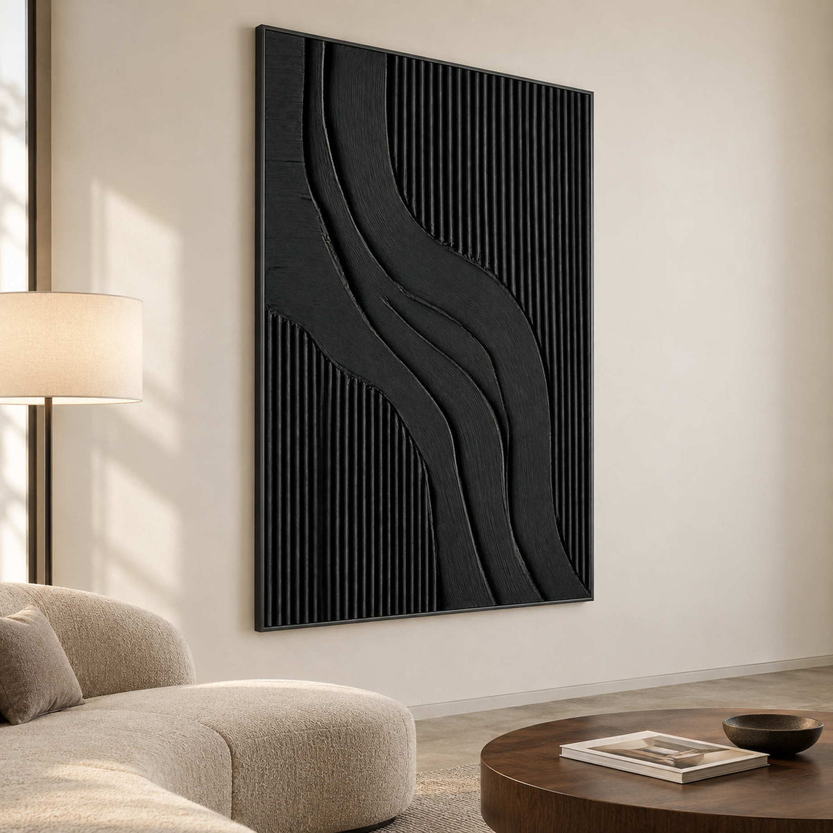 Tall black curves beside a rounded cream sofa and low brown coffee table.