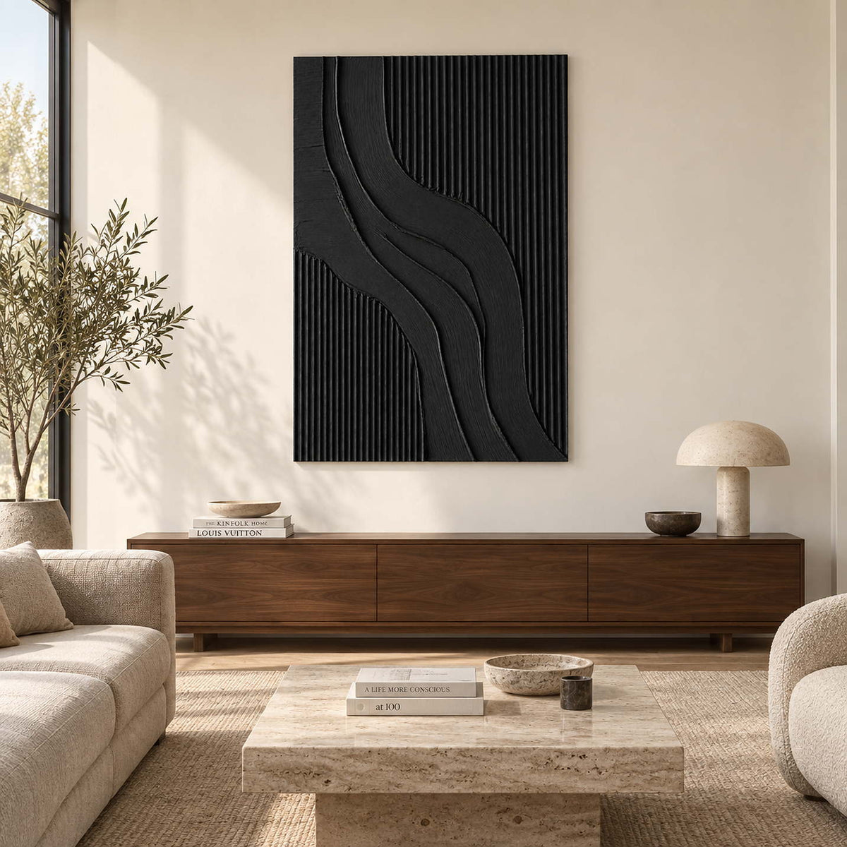 Black curved-ridge abstract above a long brown cabinet in a cream living room.