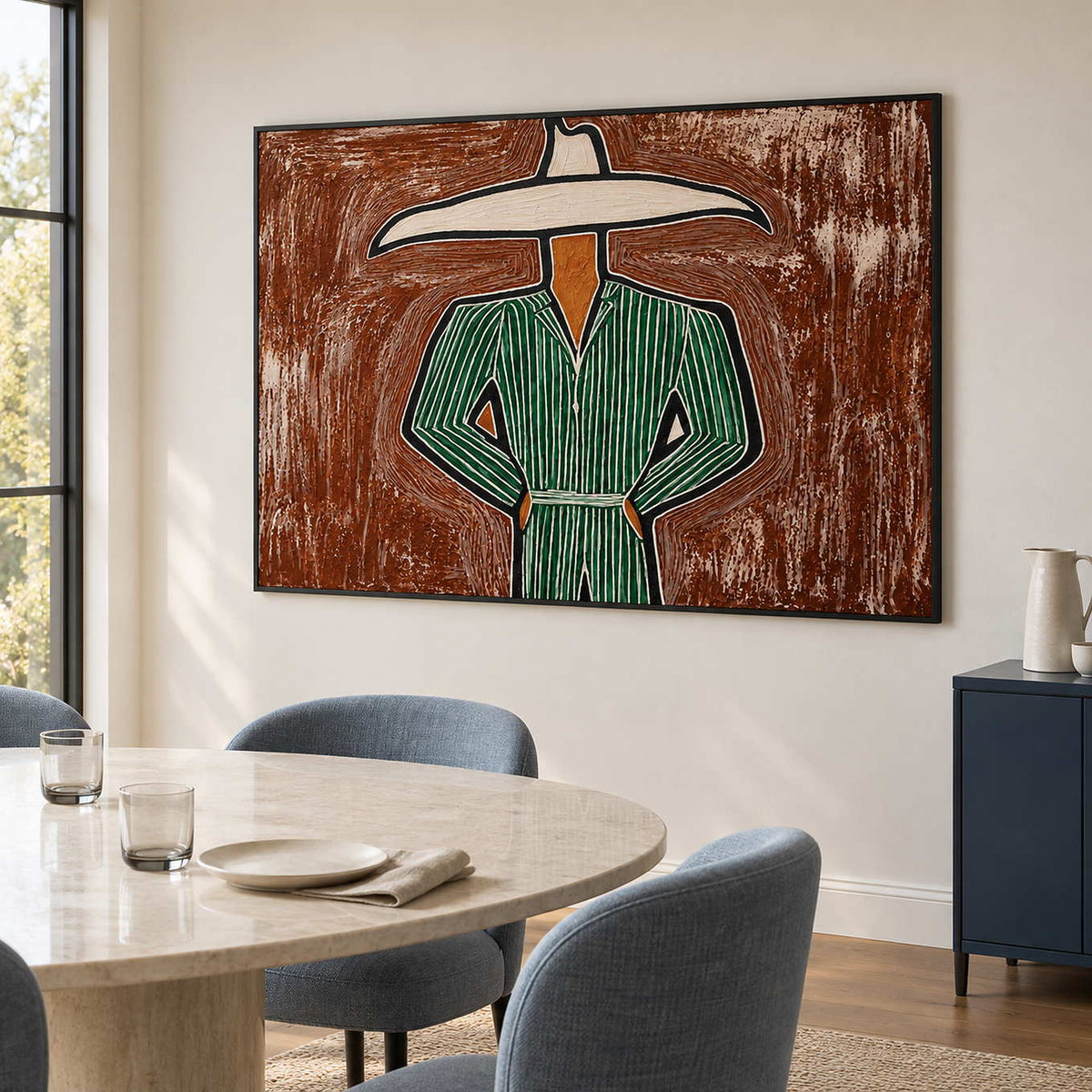 Wide hat artwork behind a pale round table and blue chairs.