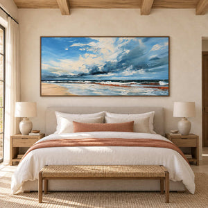 Blue-cloud seascape over a beige bed with a rust throw and a woven foot bench.