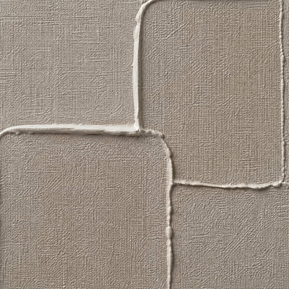 Close-up of warm gray layered blocks and fine woven canvas texture.