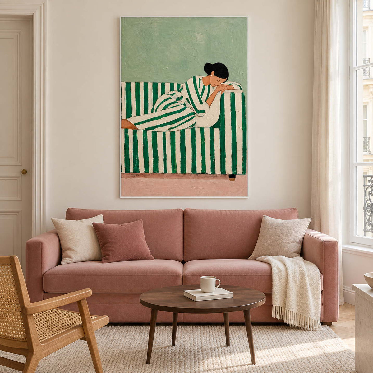 Reclining-figure artwork above a pink sofa and round wooden table.