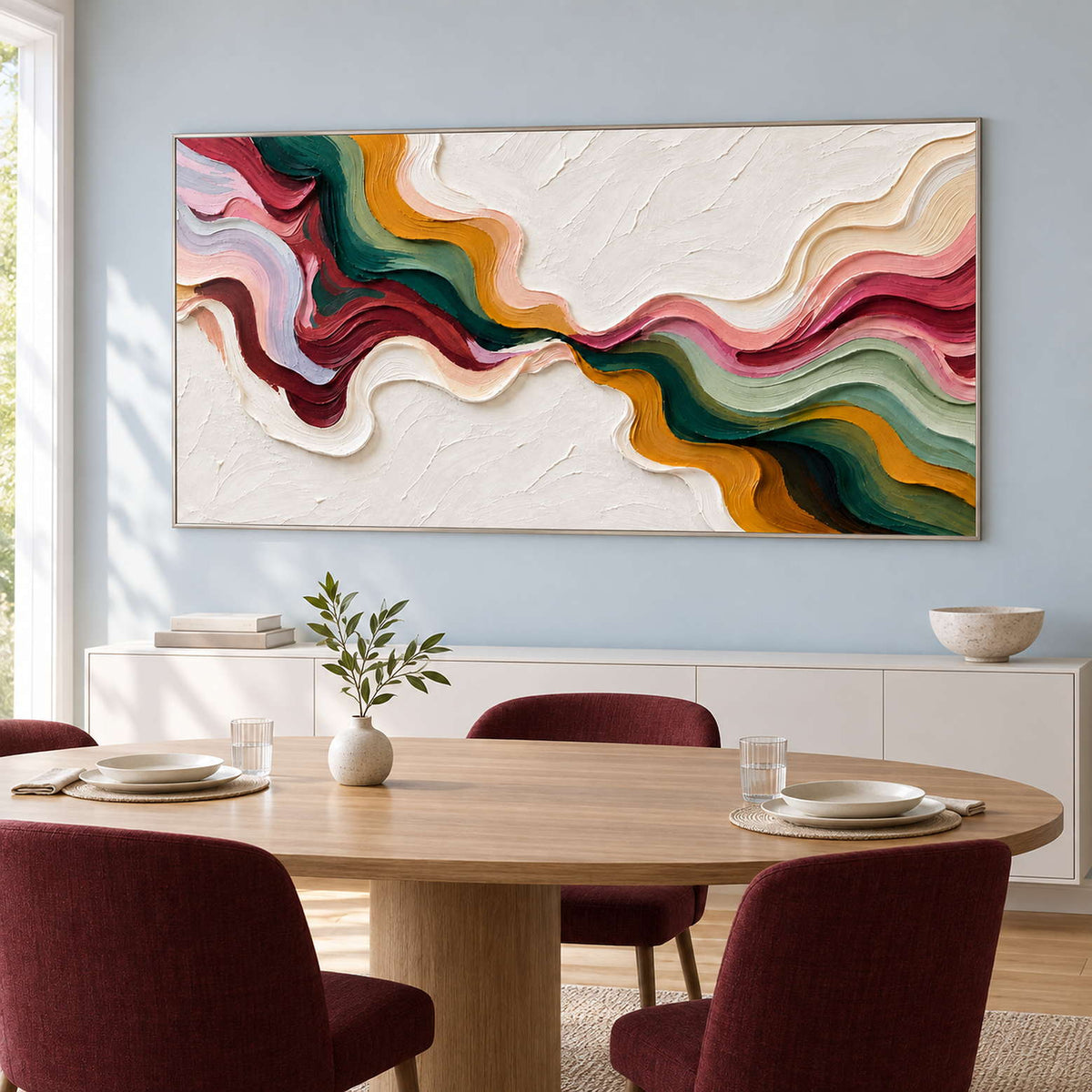 Wide abstract behind a round dining table with burgundy chairs.