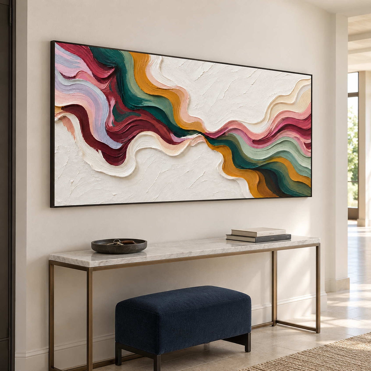 Black-framed abstract above a slim console and navy bench.