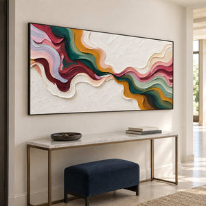 Black-framed abstract above a slim console and navy bench.
