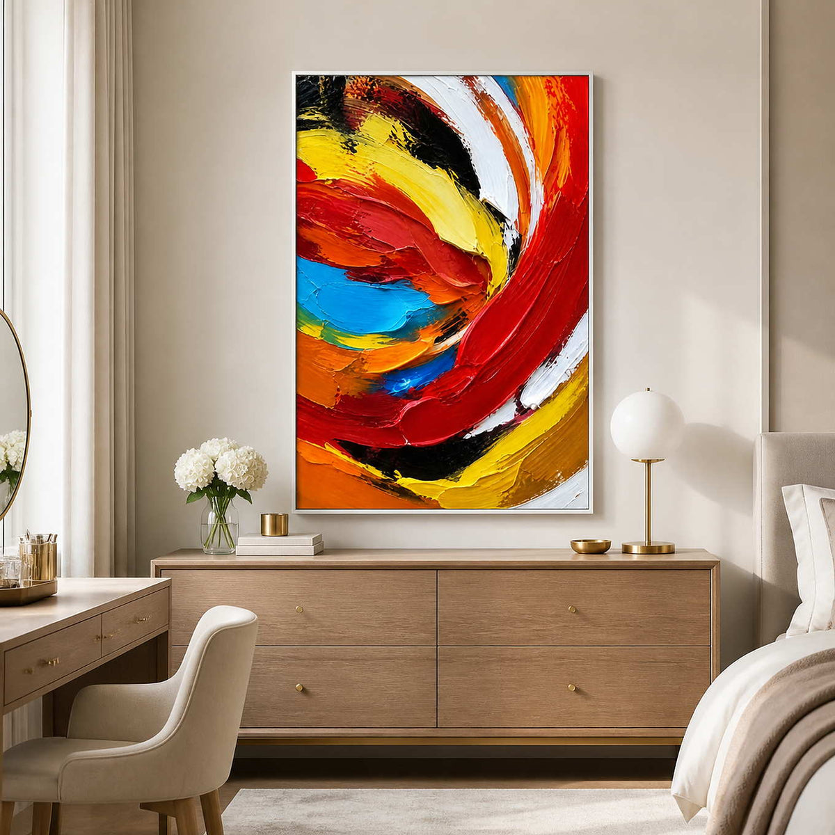 White framed red and yellow abstract artwork above a dresser beside a beige bed.