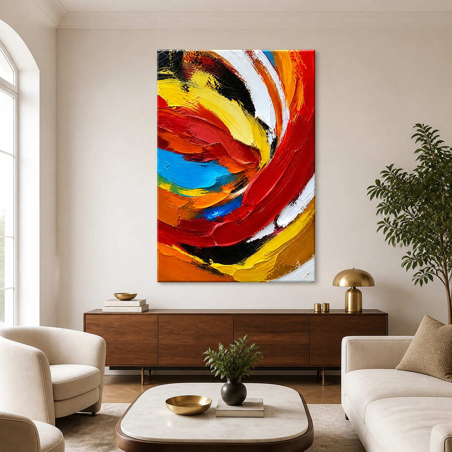 Frameless colorful swirling abstract painting above a walnut sideboard between cream seating.