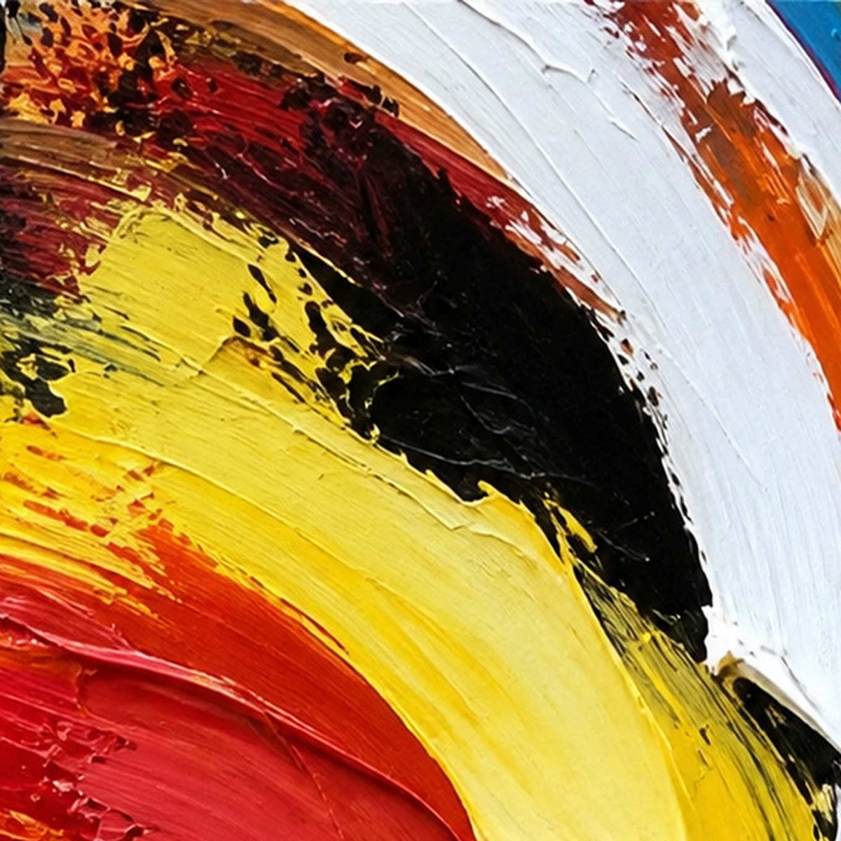 Close view of thick yellow, white, black, and red curved paint ridges.