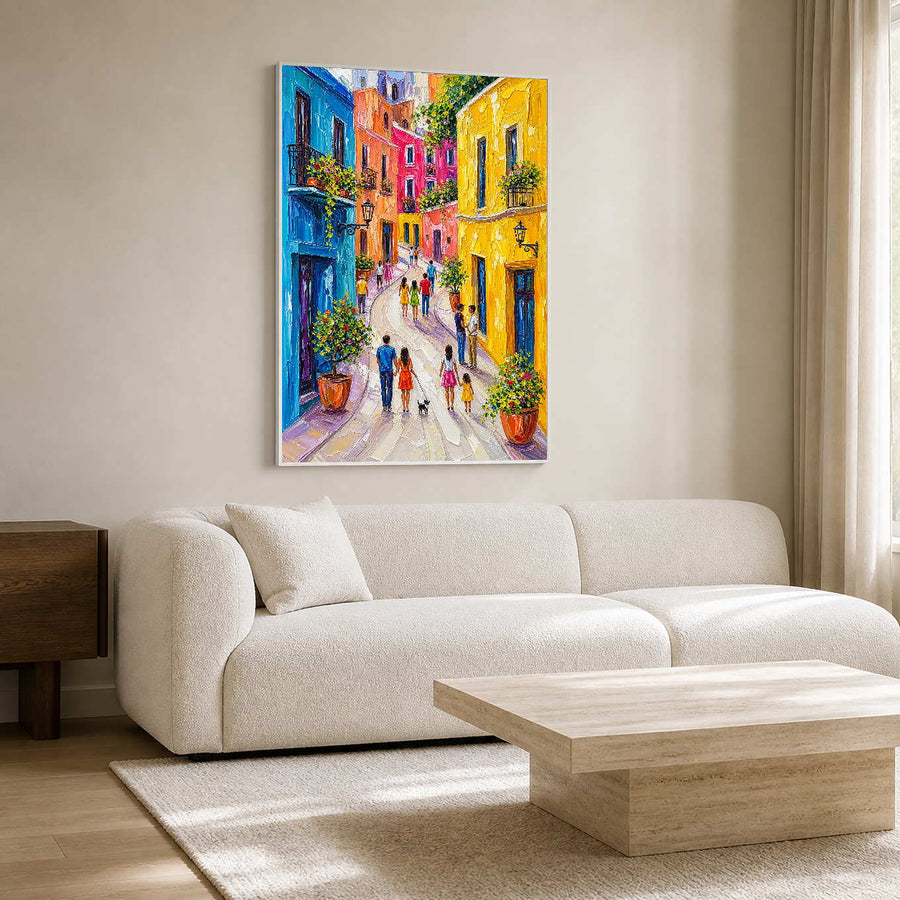 Colorful textured cityscape wall art displayed above a clean white living room sofa.