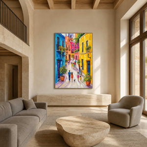 Vertical Mediterranean street wall art displayed in a spacious neutral living room.