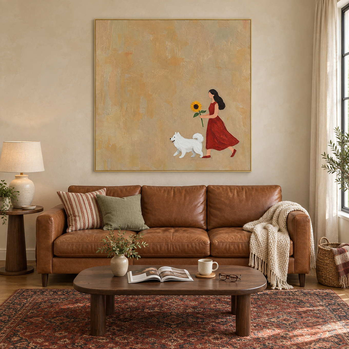 A Sunny Mood in a gold frame above a caramel leather sofa in a warm living room.