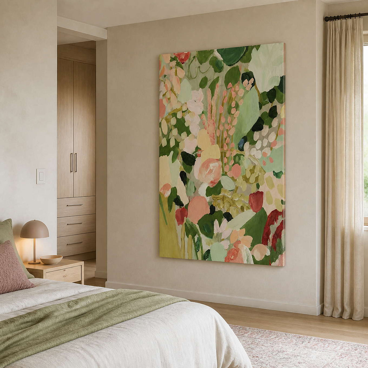 Frameless pastel floral painting beside a bed with green throw and pink cushion.