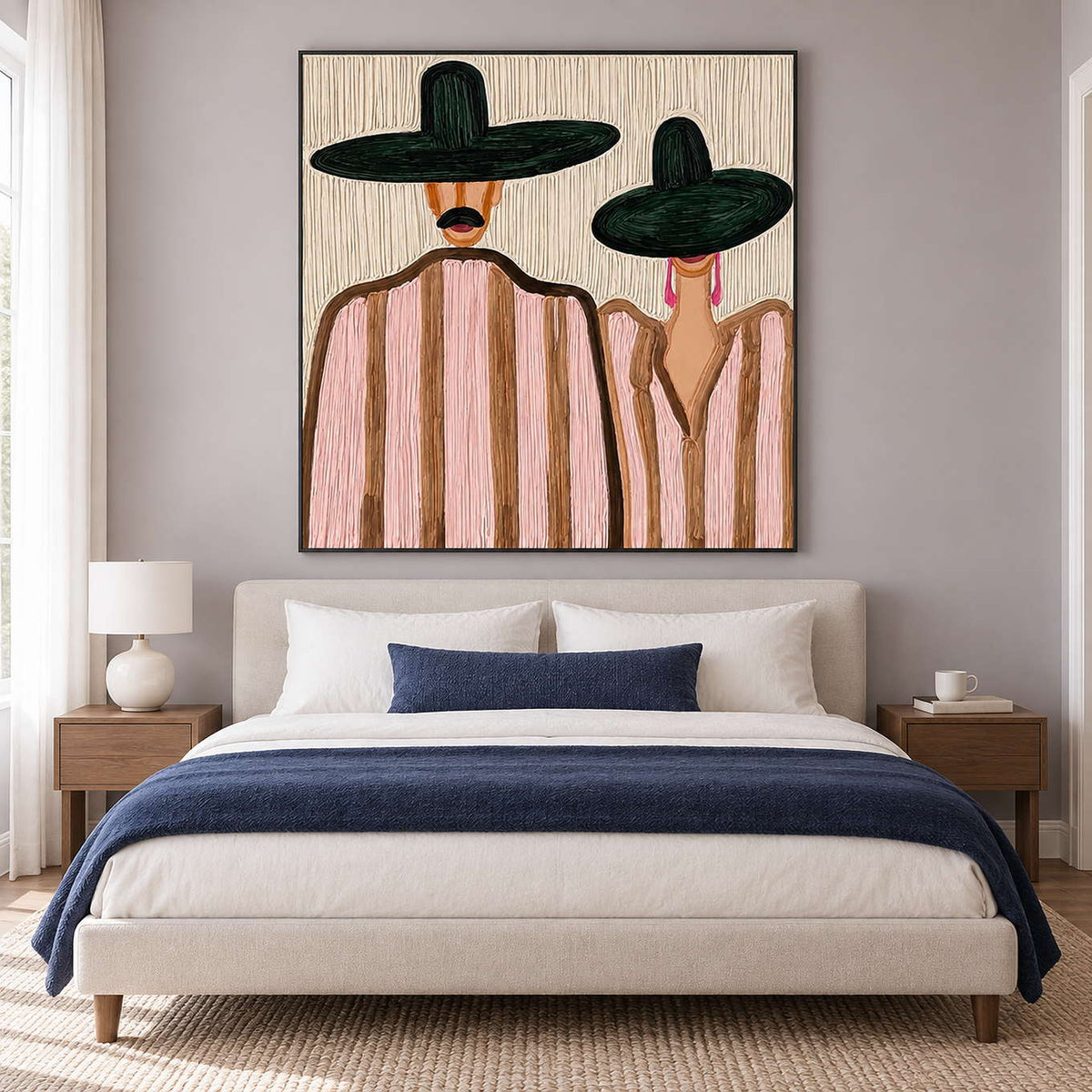 Two-hat portrait over a cream bed with navy throw and matching accent cushion.