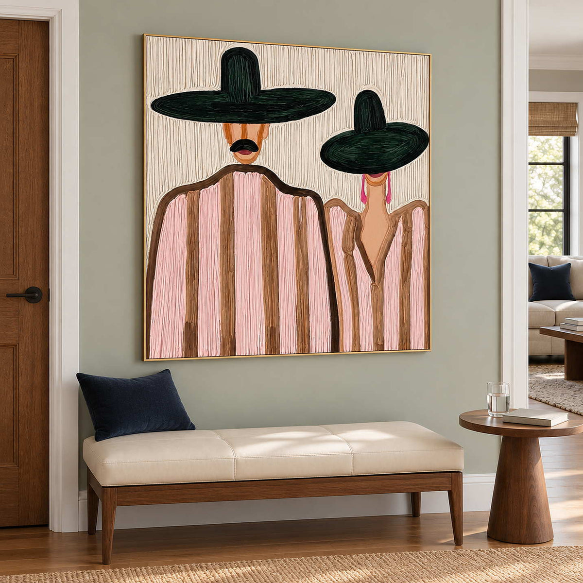 Pink-striped portrait above a cream bench with a navy cushion in a green-walled entryway.