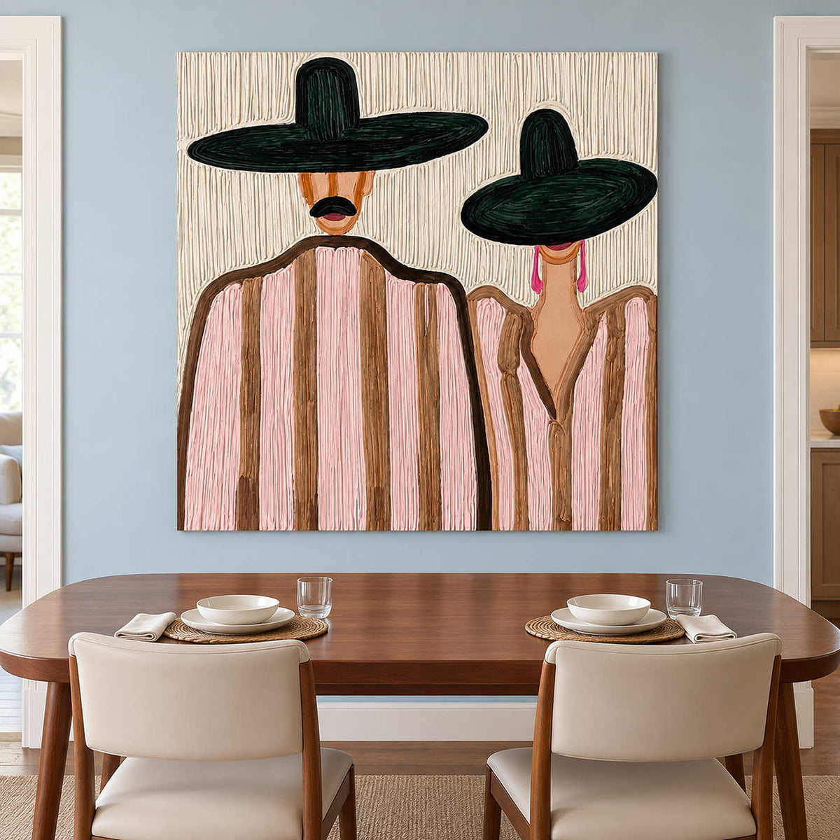 Pink-striped pair artwork above a wooden dining table with cream upholstered chairs.
