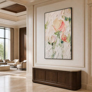 Pink floral painting above a curved wooden console beside a hotel seating area.
