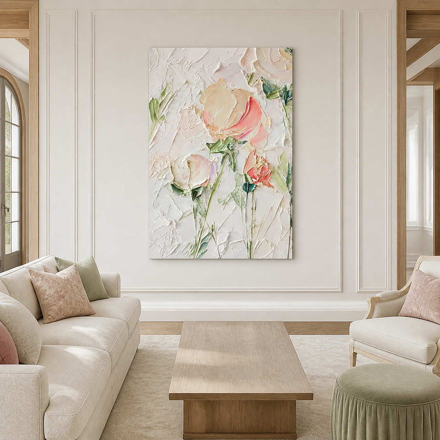 Pink floral artwork between a cream sofa and armchair in a bright living room.