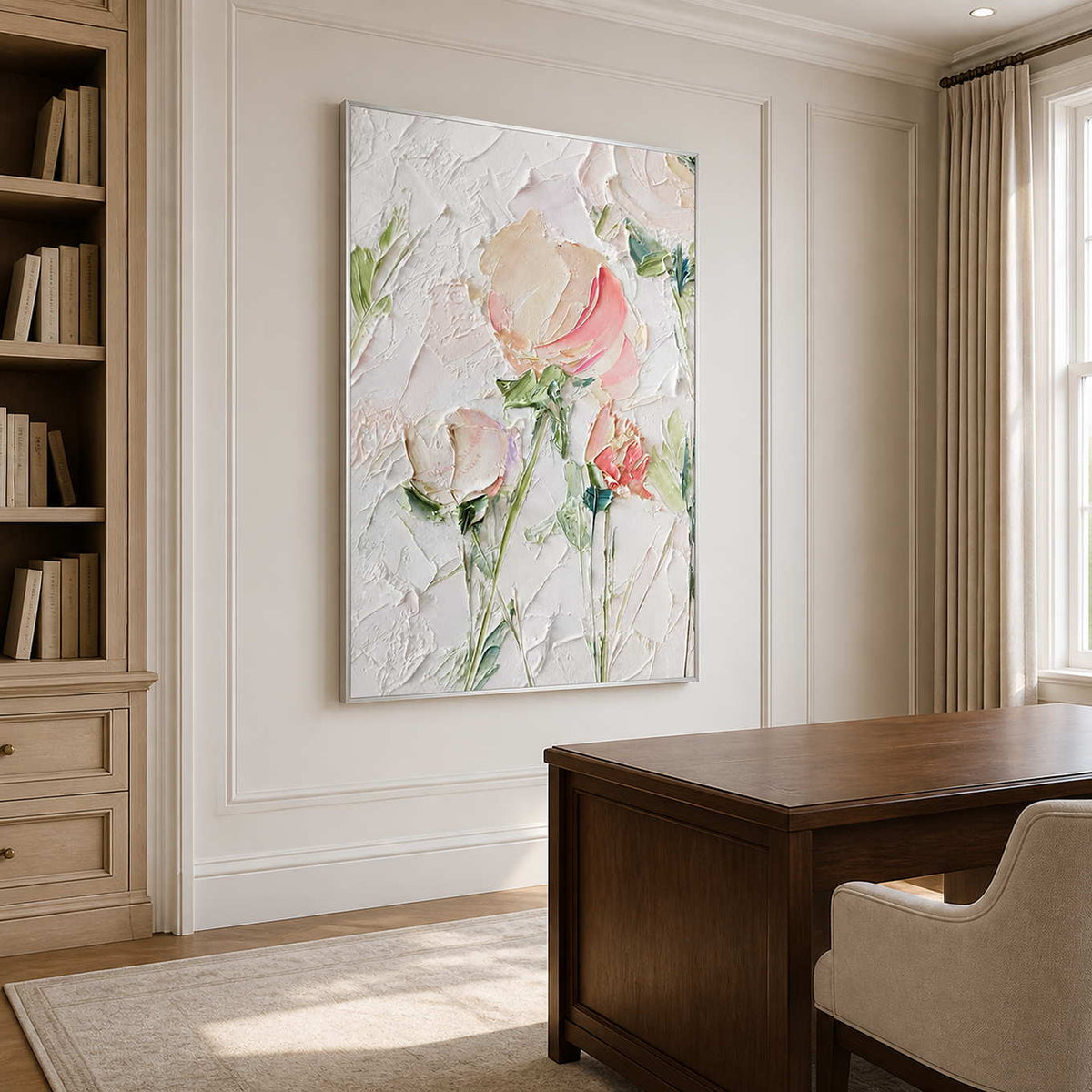 Silver framed floral artwork beside a wooden desk and bookshelves in a bright study.