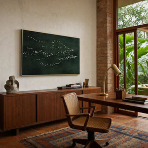 Green bird wall art accents a Brazilian modern home office.