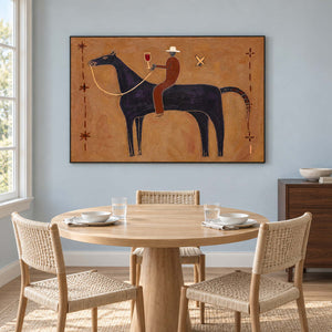 Equestrian art behind a round wooden table and woven chairs.