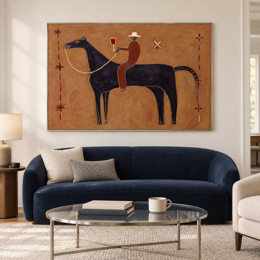 Ochre horse-and-rider painting above a curved navy sofa.