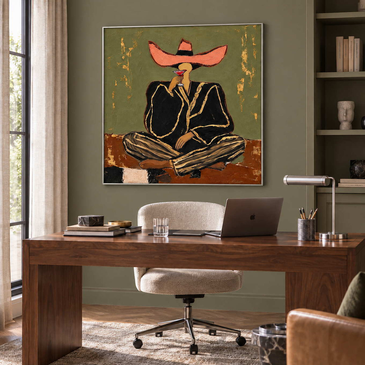 A Toast to Freedom in a silver frame above a wood desk and cream swivel chair in an olive-walled office.