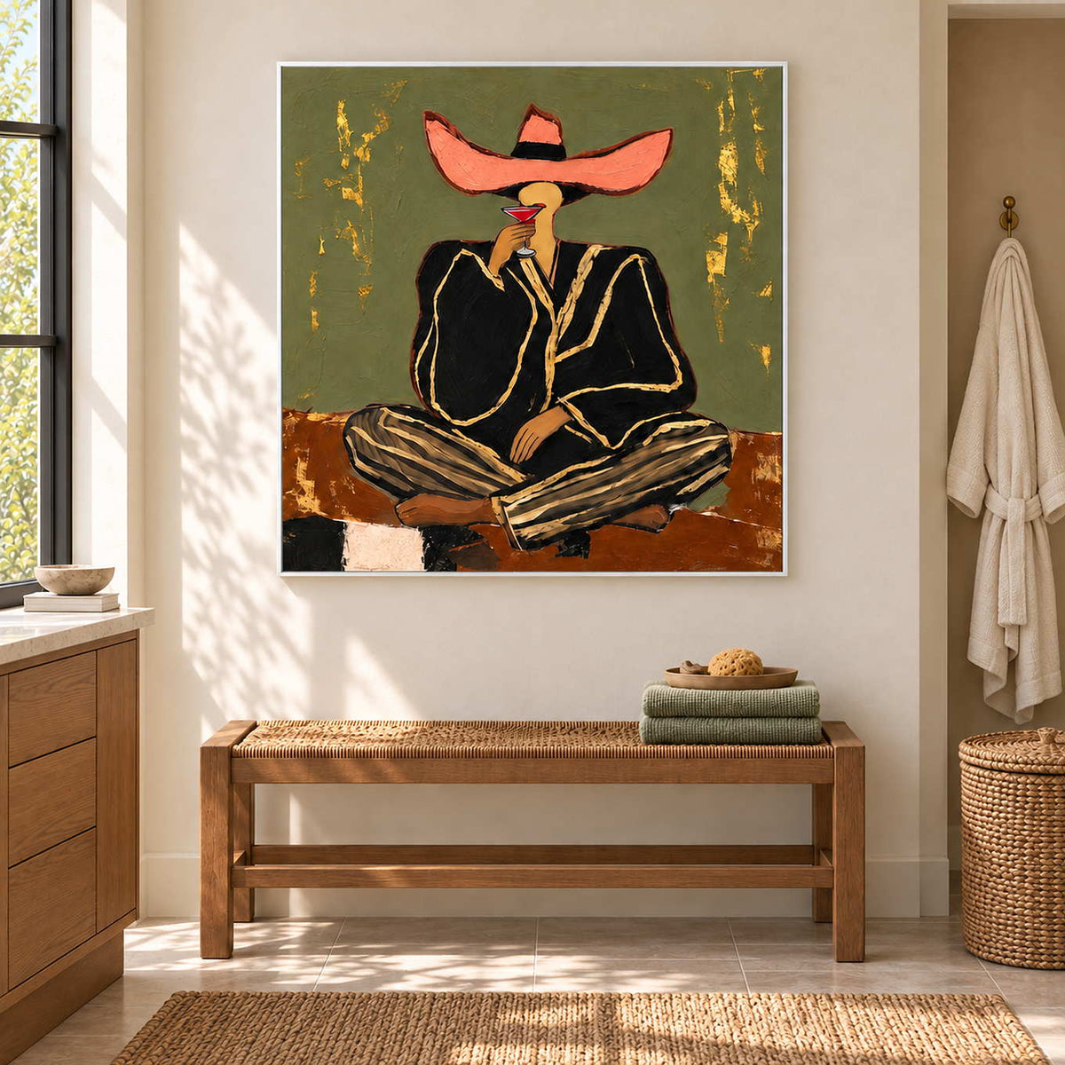 A Toast to Freedom in a white frame above a woven bench with green towels beside a bathroom vanity.