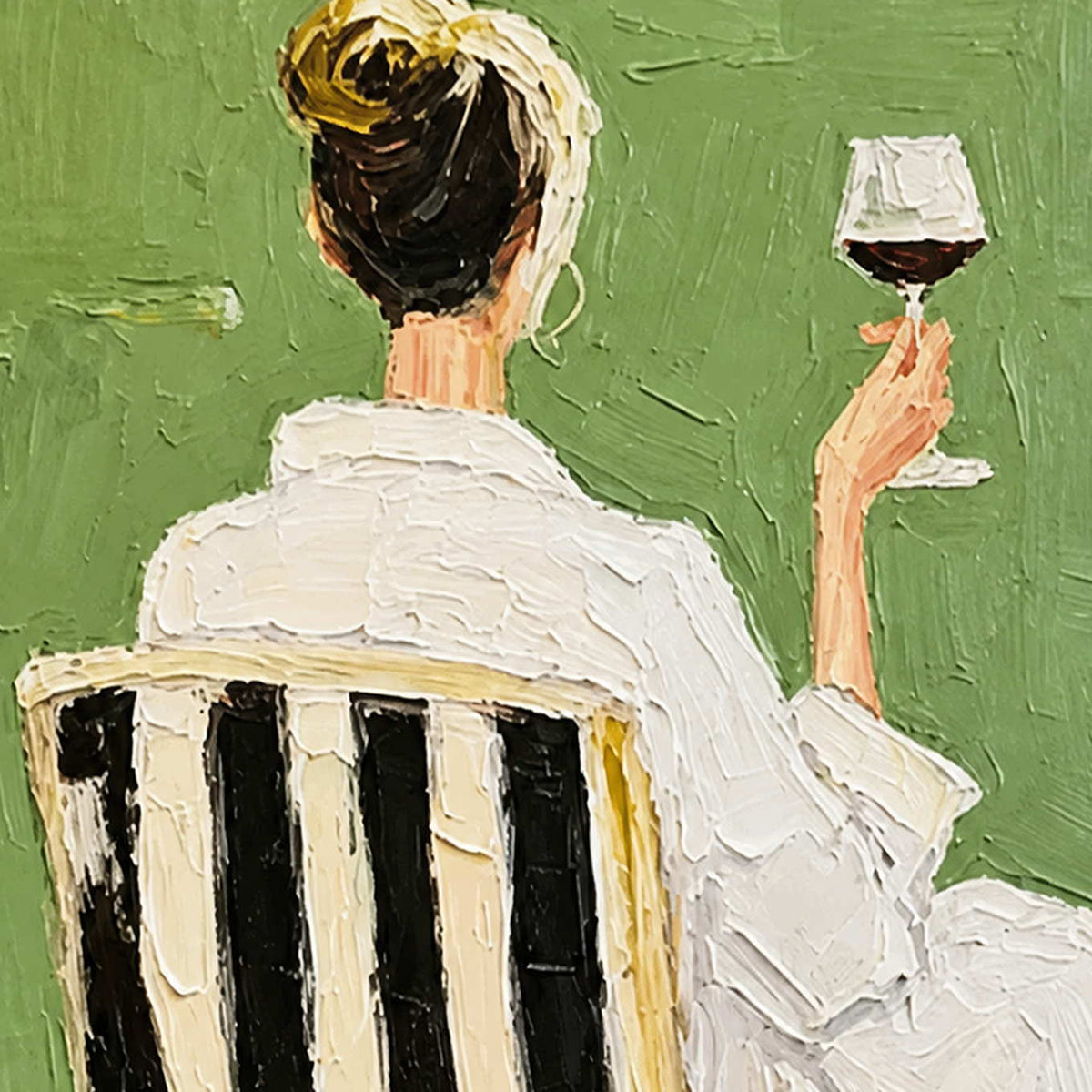 Close detail of raised white clothing, striped chair, and a hand holding red wine.