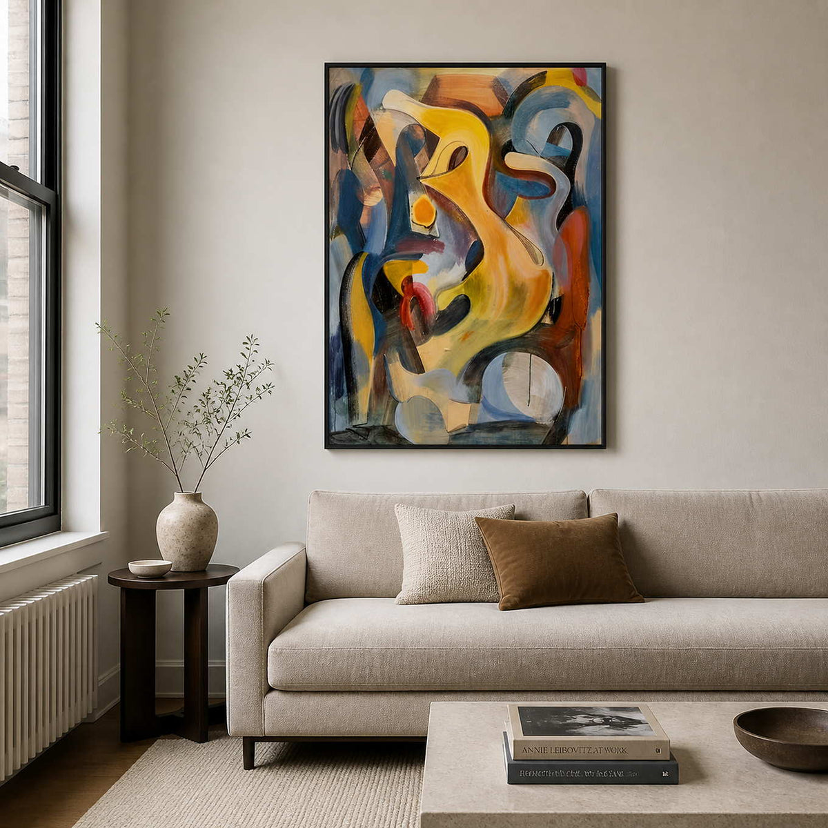 Black framed yellow and blue abstract painting above a sofa in a neutral living room.