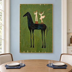 Olive equestrian painting behind a round wooden dining table with pale upholstered chairs.