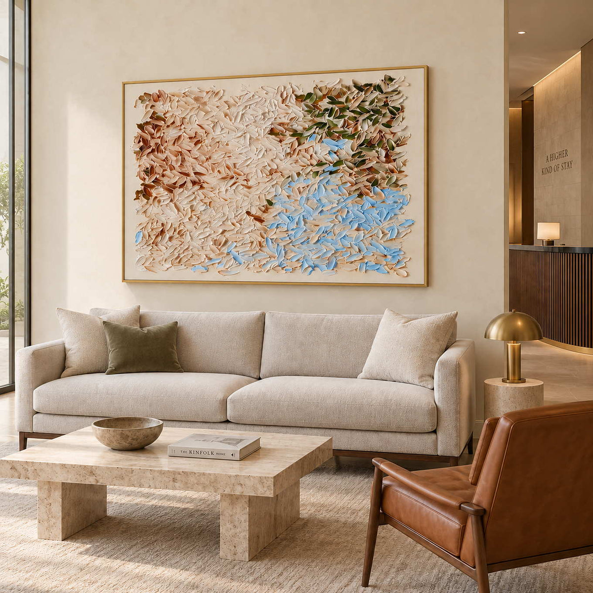 A Visit from Spring in a gold frame above a cream sofa and stone coffee table in a commercial lobby.