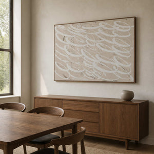 Wood framed neutral looping artwork above a wooden sideboard in a dining room.