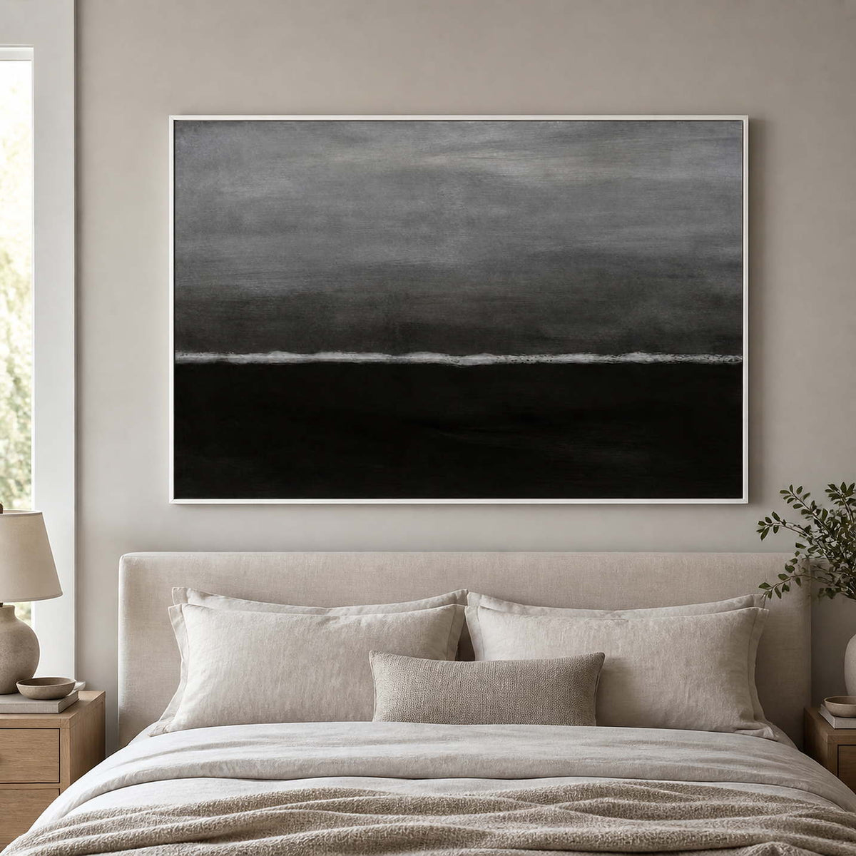 White framed horizontal wave abstraction above a padded headboard in a neutral bedroom.
