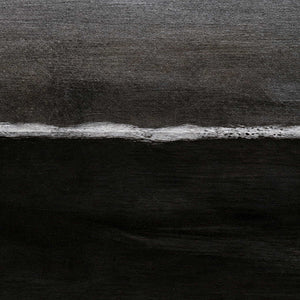 Close view of the irregular white wave line between charcoal gray and black paint.