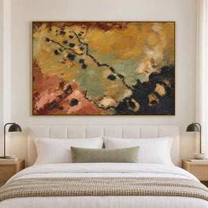 Weathered ochre, moss green and rust tones crossed by dark marks in a gold frame, displayed above a bed.