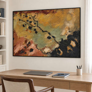 Weathered ochre, moss green and rust tones crossed by dark marks in a black frame, displayed in a home office.