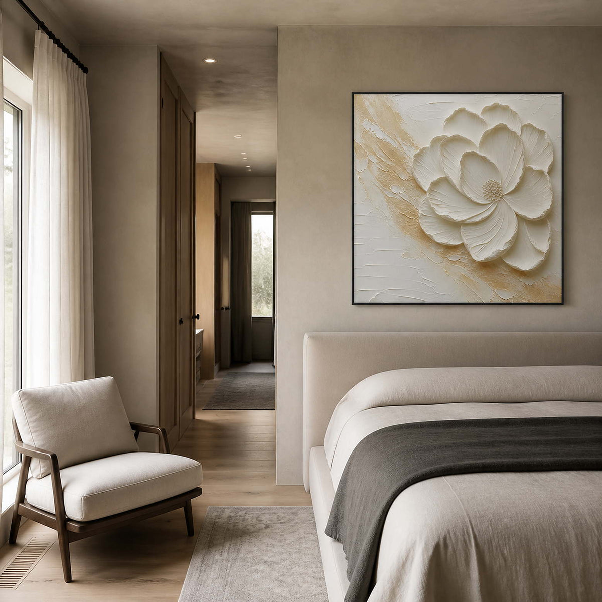 White sculptural flower styled in a soft gray-beige bedroom sitting area.