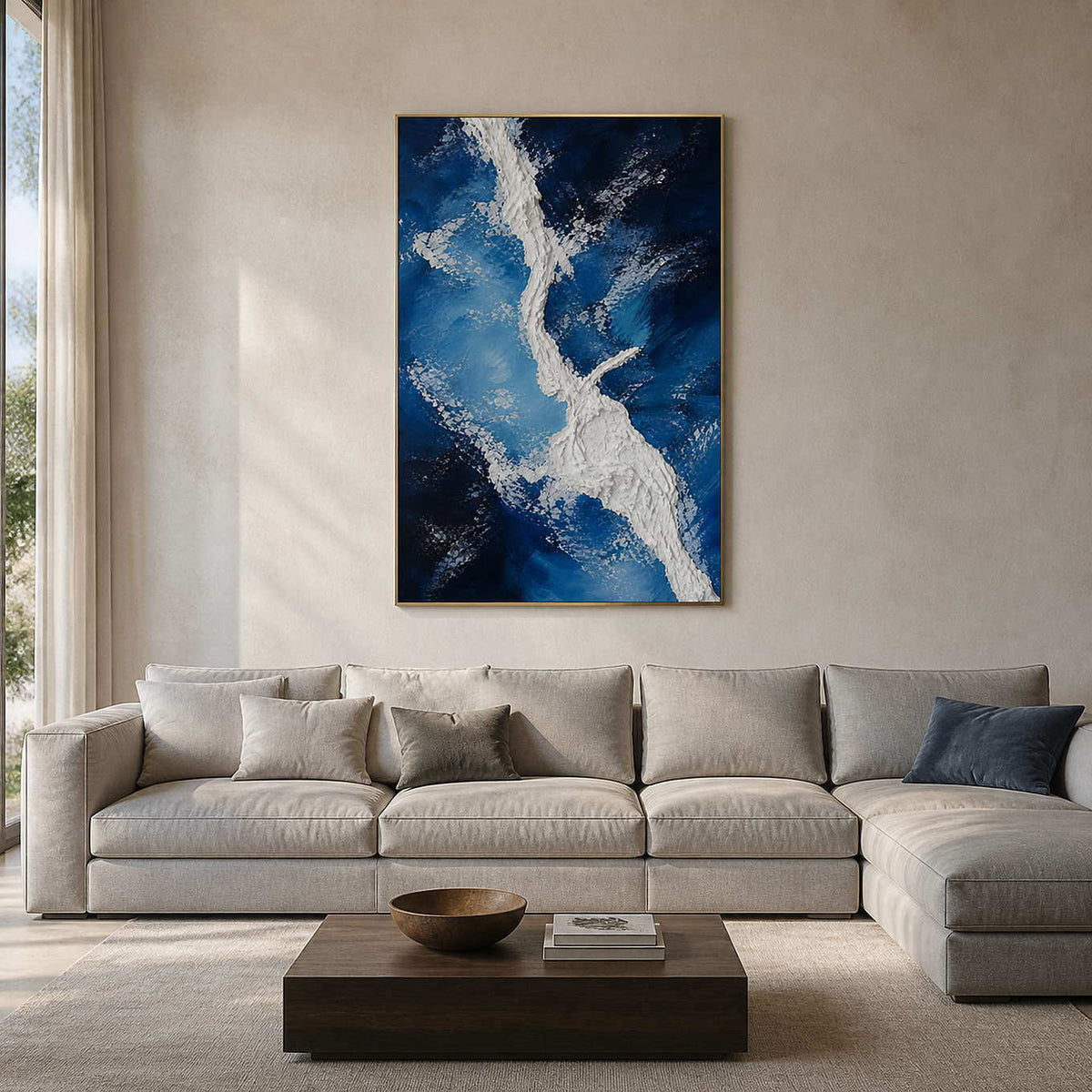 Blue and white textured coastal wall art in a warm modern living room.