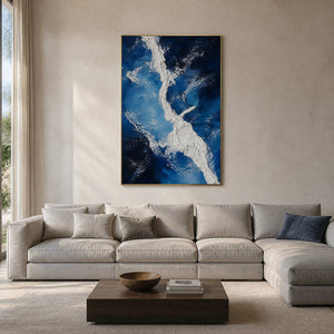 Blue and white textured coastal wall art in a warm modern living room.