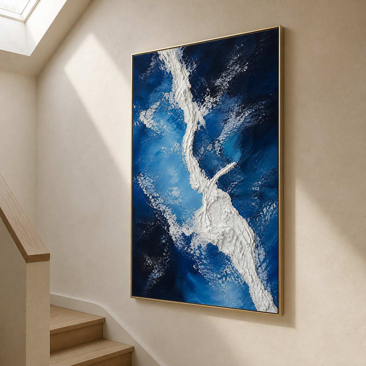 Vertical coastal artwork bringing blue movement to a light stair hall.