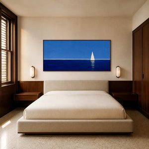 Blue sailboat wall art displayed above a serene modern bed.