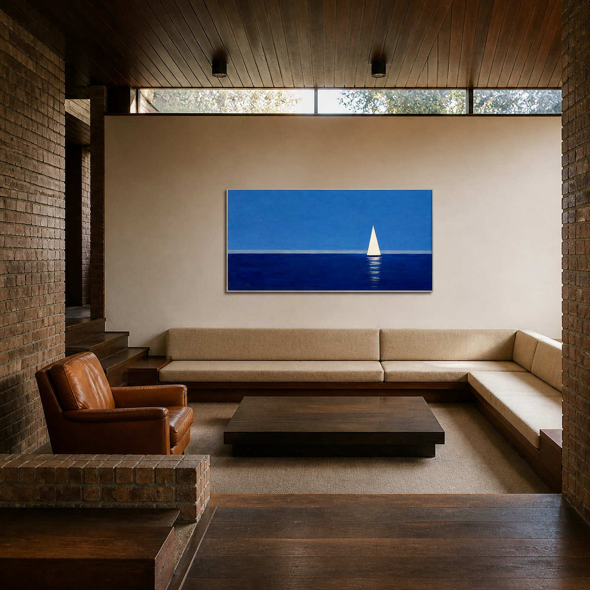 Blue sailboat wall art displayed in a relaxed sunken lounge.