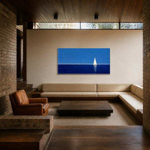 Blue sailboat wall art displayed in a relaxed sunken lounge.