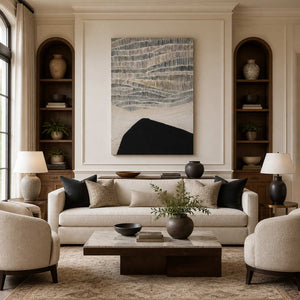 Frameless gray and cream abstract artwork above a sofa between arched wooden shelves.