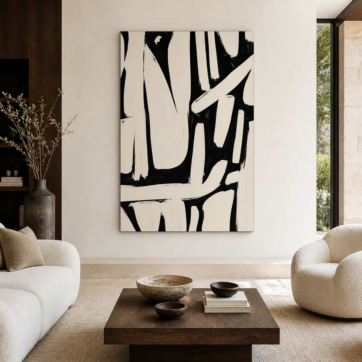 Frameless cream and black abstract artwork above a wooden table between cream living room seating.