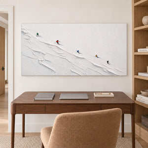 Tiny colorful skiers crossing a ridged white slope without an outer frame, displayed in a home office.
